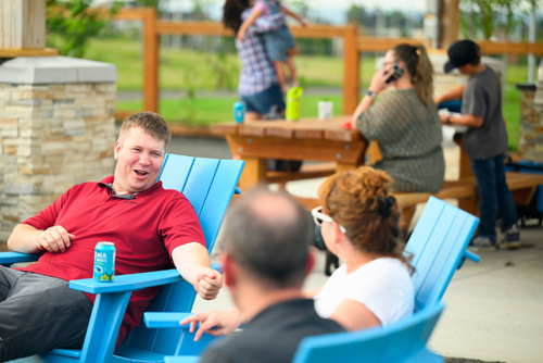 A group of Reed’s Crossing residents gather to chat around a community firepit.
