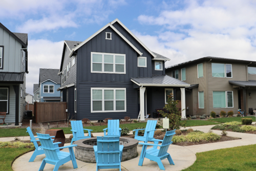 New homes for sale in Reed’s Crossing with a community firepit and Adirondack chairs.