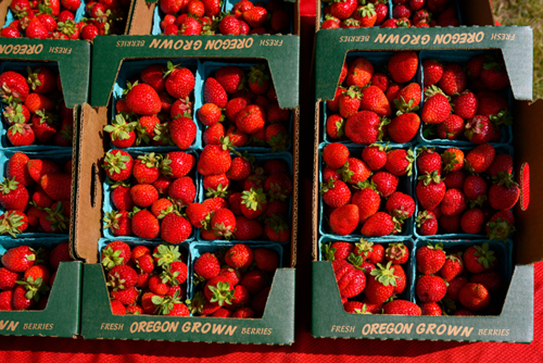 Boxes full of ripe, red strawberries at Hillsboro Farmers’ Market at Reed’s Crossing.