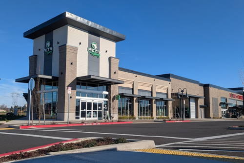 A wide shot of Town Center at Reed's Crossing, featuring Pets on Broadway and Market of Choice.