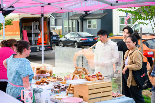 Customers at the Hillsboro Farmers’ Market at Reed’s Crossing peruse various sweet pastries.
