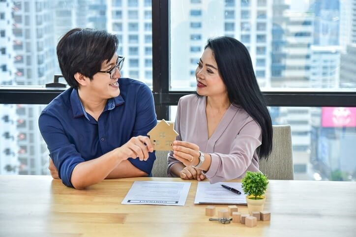 Young Couple Home Signing Contract