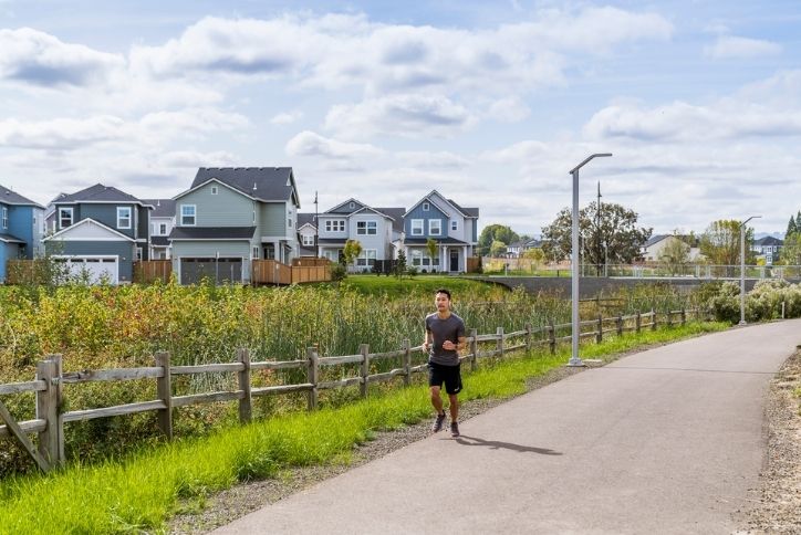 A man jogs along the paths at Reed’s Crossing.