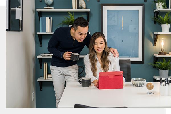 Couple working at computer in their new home in Hillsboro, Oregon