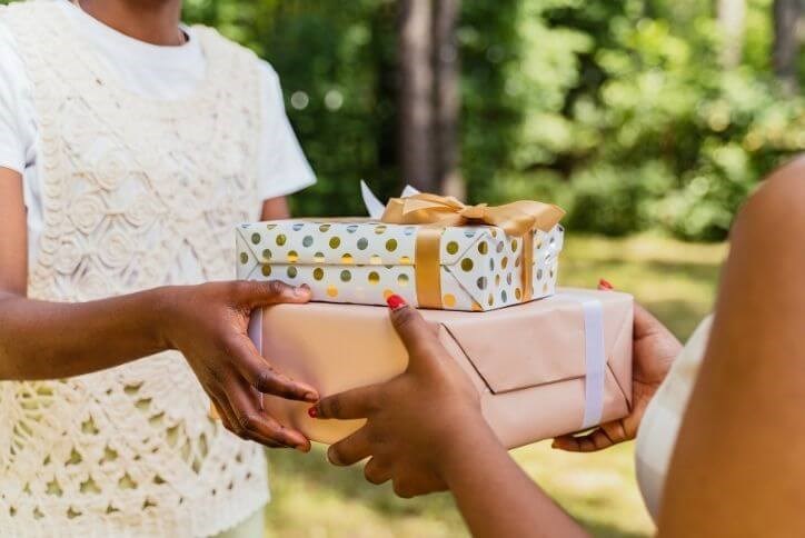 Two people exchanging gifts.