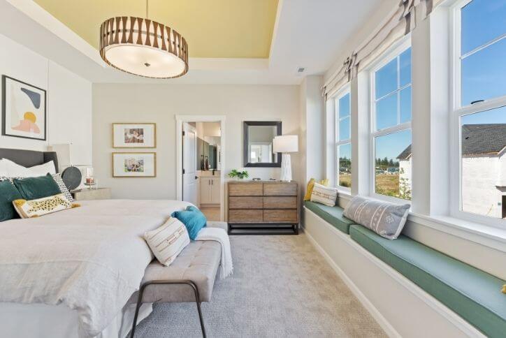 A bedroom decorated in tones of yellow and teal at Reed’s Crossing in Hillsboro.