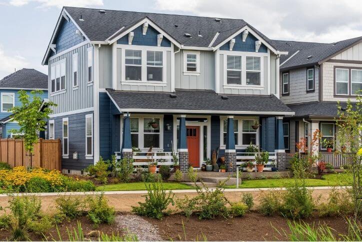 A blue house with a cheerful red door in Hillsboro, Oregon.