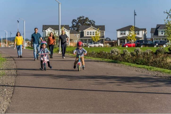 Children riding bicycles on a sunny day.