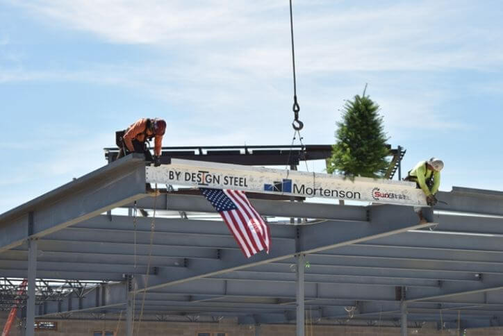 Alt text: The last beam is placed atop the new Providence facility in Hillsboro.