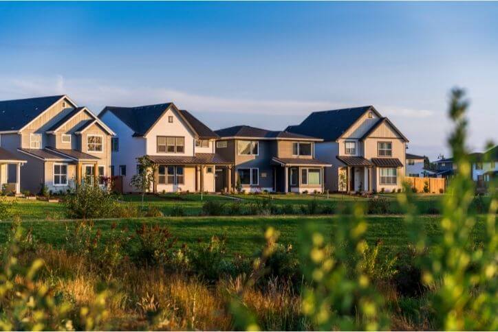 A row of modern, angular homes against sunset sky at Reed’s Crossing.