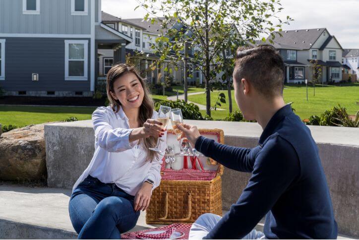 Say cheers! A young Asian couple enjoys a picnic in Hillsboro.