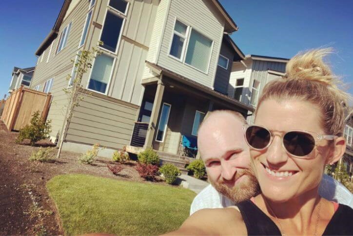 Reed’s Crossing pioneers Mike and Abby pose in front of their new home in Hillsboro, Oregon.