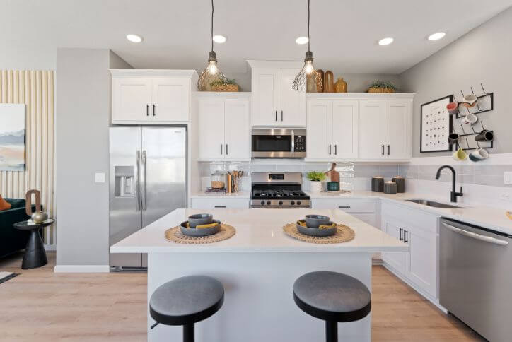 A bright white kitchen in the Ross Island home plan from David Weekley in Reed’s Crossing.