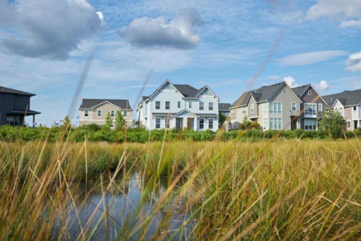 Three homes line a field of grass at Reed’s Crossing in Hillsboro, Oregon.