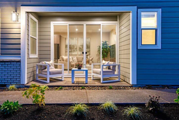 Large sliding glass doors and comfortable seating create a seamless indoor-outdoor living area.