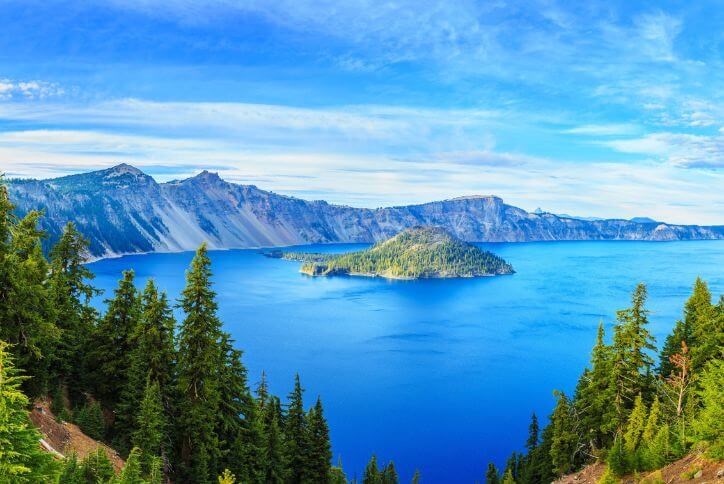 Aerial photo of Crater Lake, Crater Lake National Park, and surrounding forest in Oregon.