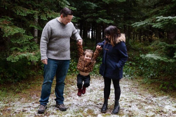 Family photo of residents at Reed’s Crossing features a father, mother, and young daughter.