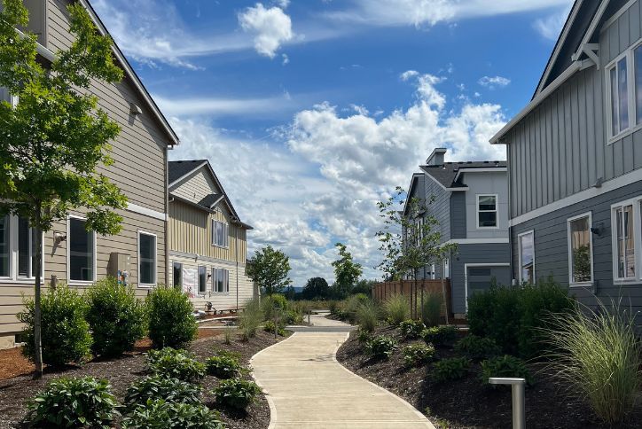 A walking path winds between new construction homes for sale in Reed’s Crossing.