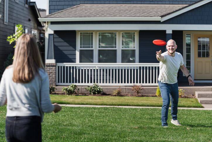 A man tosses a red frisbee in Hillsboro’s Tamarack Park.