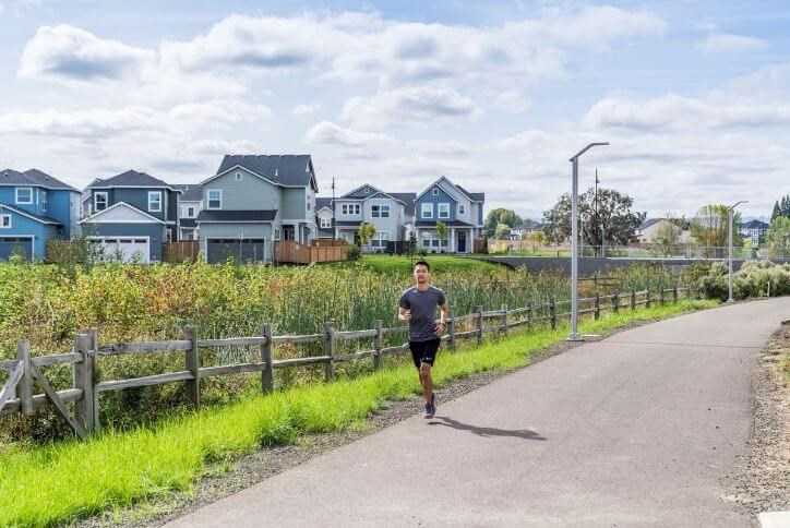 A man runs along a neighborhood greenway in Reed’s Crossing, located in Hillsboro, Oregon.