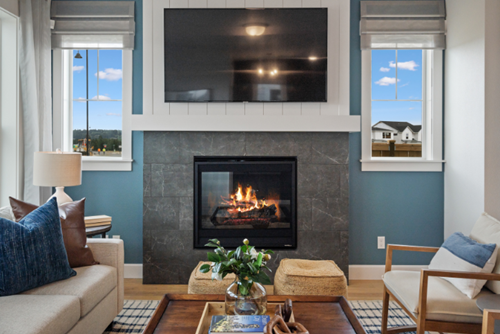 An energy-efficient fireplace warms the living area of a David Weekley home in Reed’s Crossing.
