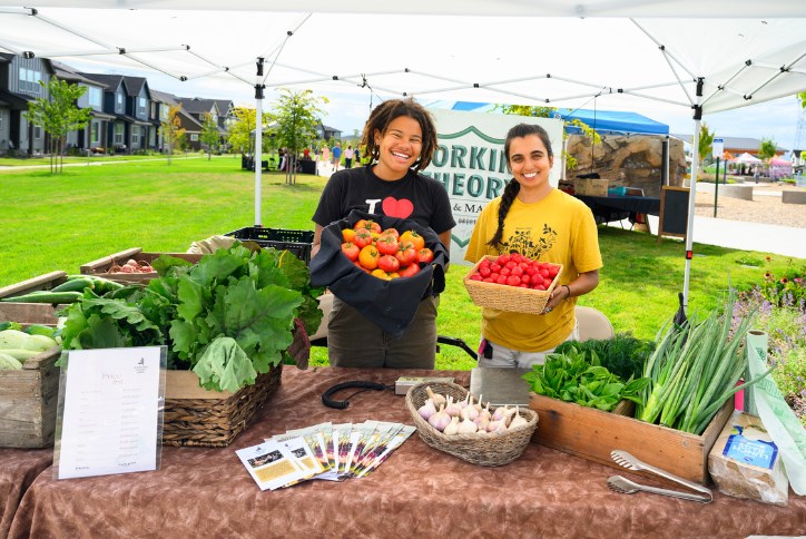 Farm workers pose with a table full of produce at Hillsboro Farmers’ Market in Reed’s Crossing