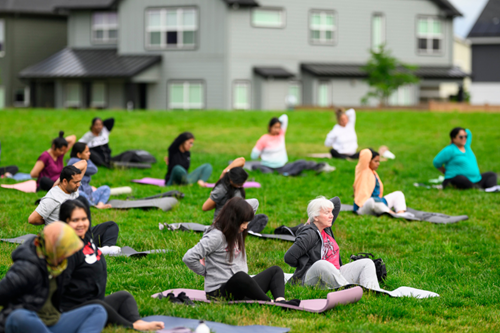Reed’s Crossing residents gather for weekly yoga in the park sessions.