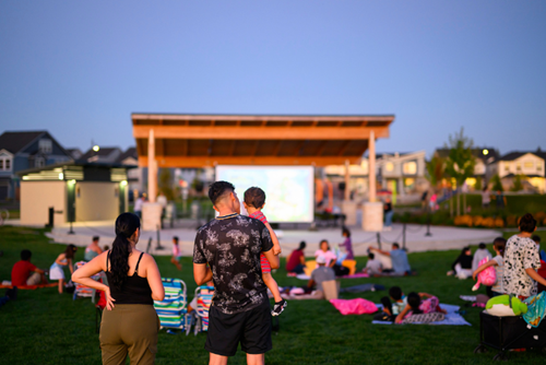 Reed’s Crossing residents gather at dusk for a movie in the park.