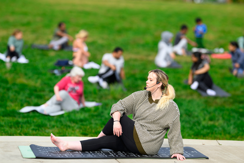 A resident yoga instructor teaches weekly yoga in the park at Reed’s Crossing.