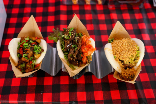 Three varieties of bao from Nom Nom Bao on a table at the Reed’s Crossing Farmers’ Market.