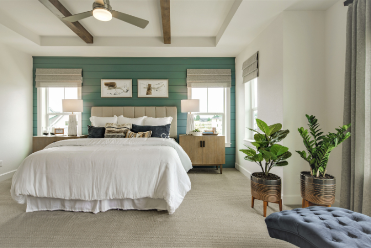 A light-filled bedroom in a home for sale in Hillsboro, featuring soothing sage green walls.