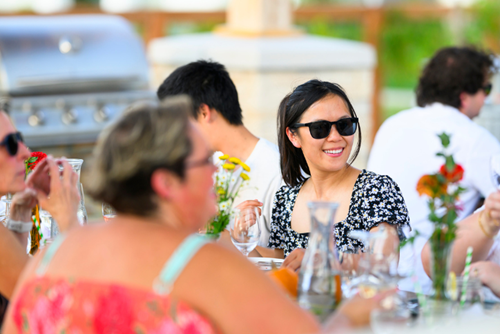 A woman enjoys an outdoor meal with neighbors in the Reed’s Crossing Community Garden.