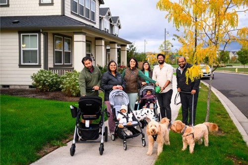 Three families walk in Tamarack Park in Reed’s Crossing with their dogs.