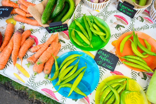 Freshly picked carrots, peppers, and cucumbers are on display at the Hillsboro Farmers’ Market at Reed’s Crossing.