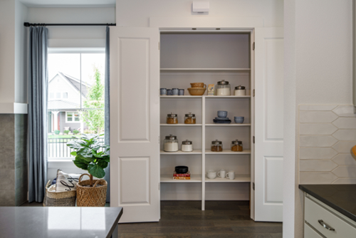 A built-in pantry offers extra storage in a new construction home.