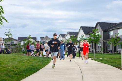 Residents of Reed’s Crossing in Hillsboro, Oregon take off from the starting line at the annual 5K.