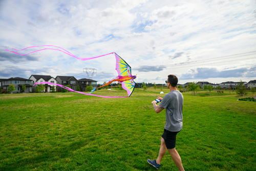A man flies a brightly-colored kite at Reed’s Crossing Park in Hillsboro, Oregon.