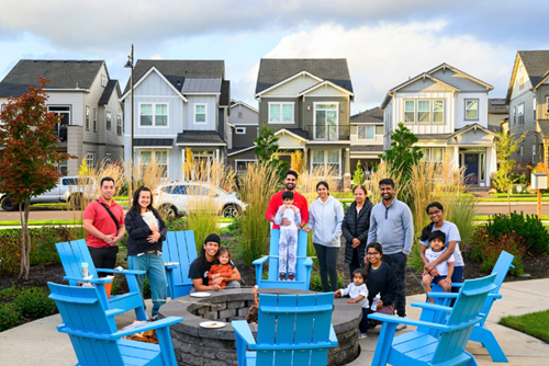 A group of Reed’s Crossing residents gather at a community firepit to roast marshmallows.