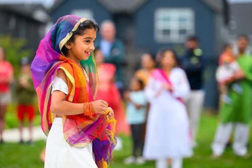 A young girl in a colorful sari performs in an event at Reed’s Crossing Park.