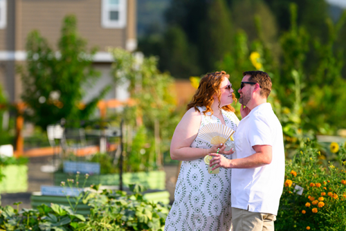 A couple shares a kiss in the Reed’s Crossing Community Garden.