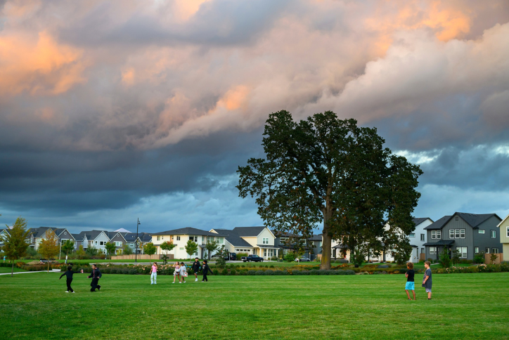 Children play under the historic oak tree in Hillsboro’s Tamarack Park.
