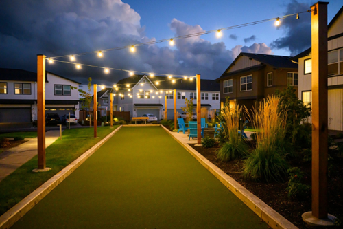 String lights illuminate a fire pit and bocce ball court in Hillsboro’s Reed’s Crossing community.